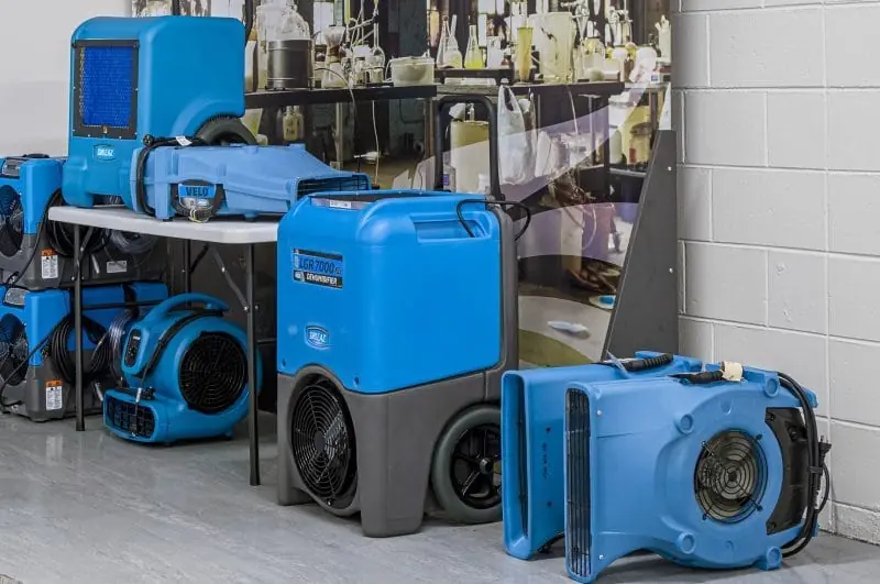 Commercial dehumidifier pulling moisture from a drying room